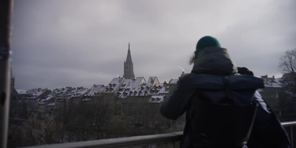 Tourists taking photos of the Bern, Switzerland skyline in winter