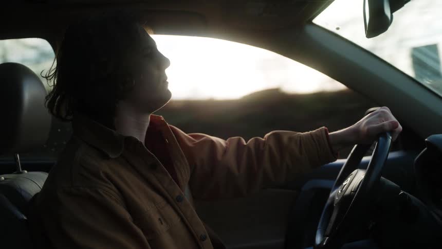 A man is driving his car