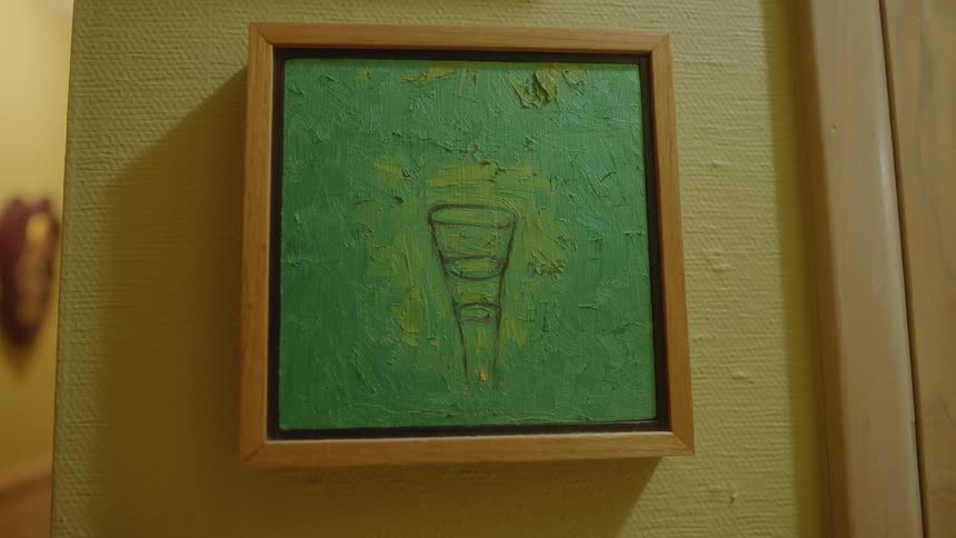 A small painting is hanging on the wall