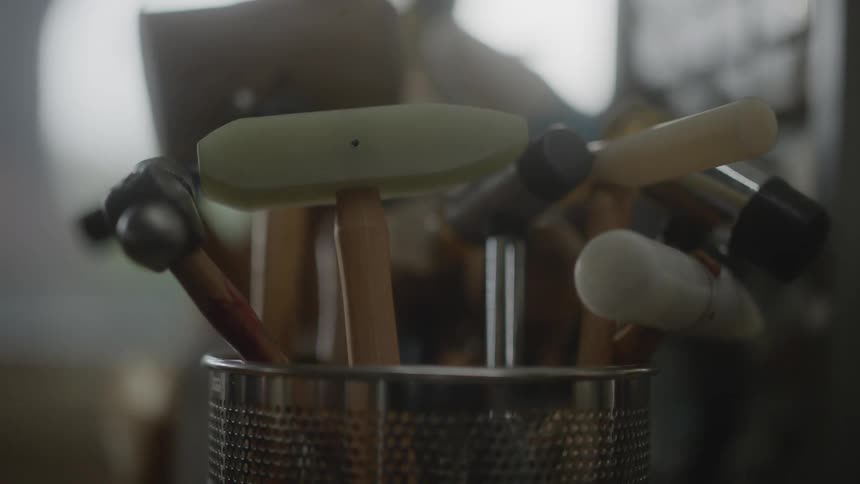 Pot with small hammers indoors