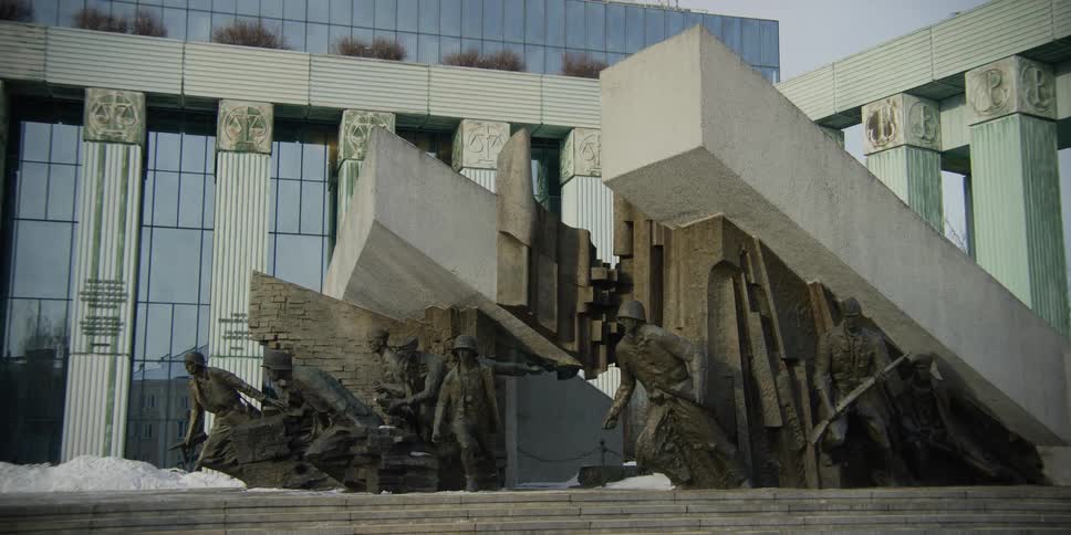 The Monument to the Warsaw Uprising Fighters of 1944 with Supreme Court of Poland building behind.