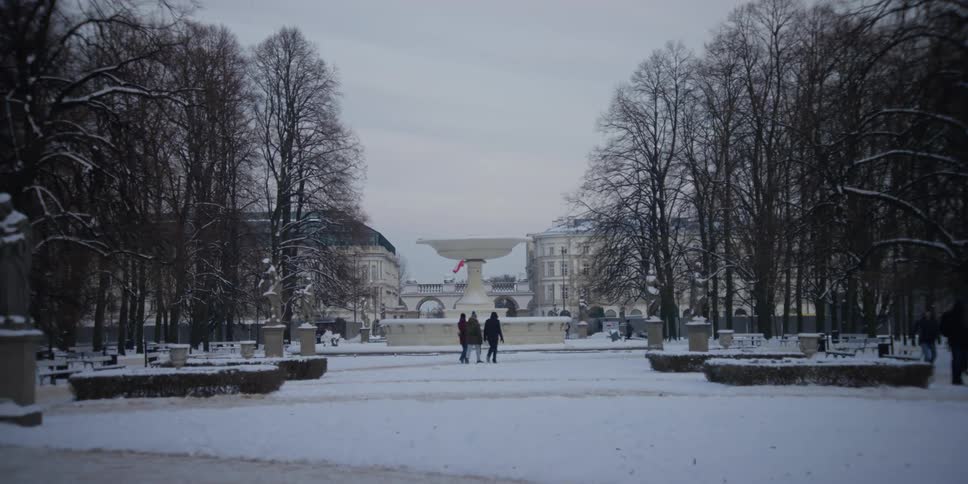 A group of people walking around the Saxon Garden Warsaw, Poland