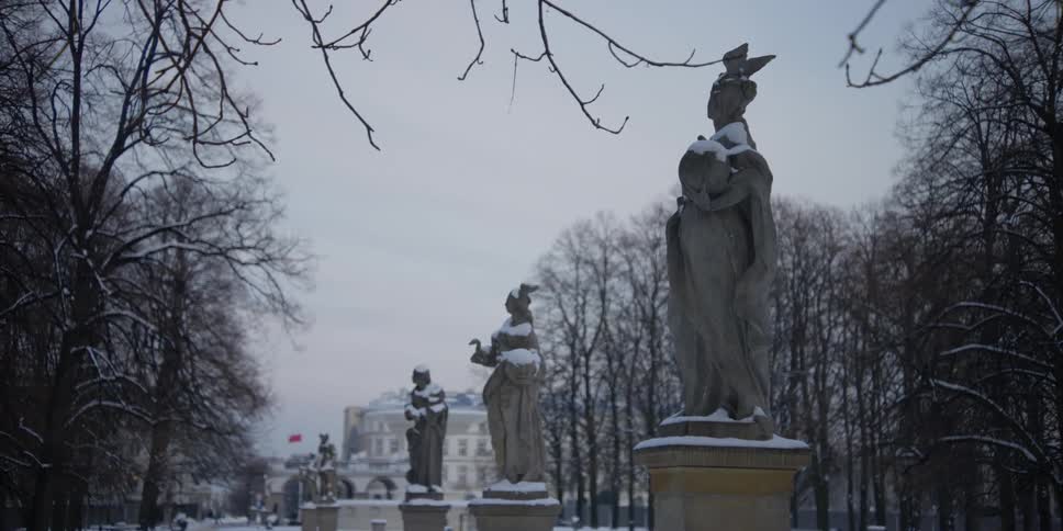 Pillars with sculptures in Saxon Garden, Warsaw, Poland on a snowy winter day