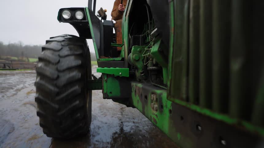 A tractor is moving on the farm