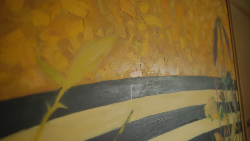 Close up of an abstract painting over a textured wall