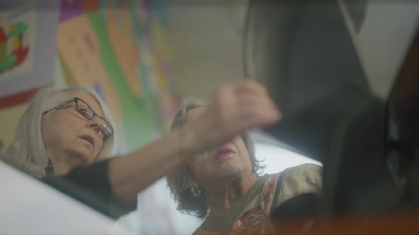 Two women talk in a room