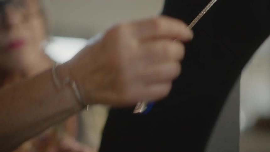 Woman hand analyzing a necklace