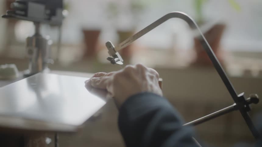 A person is sawing an object