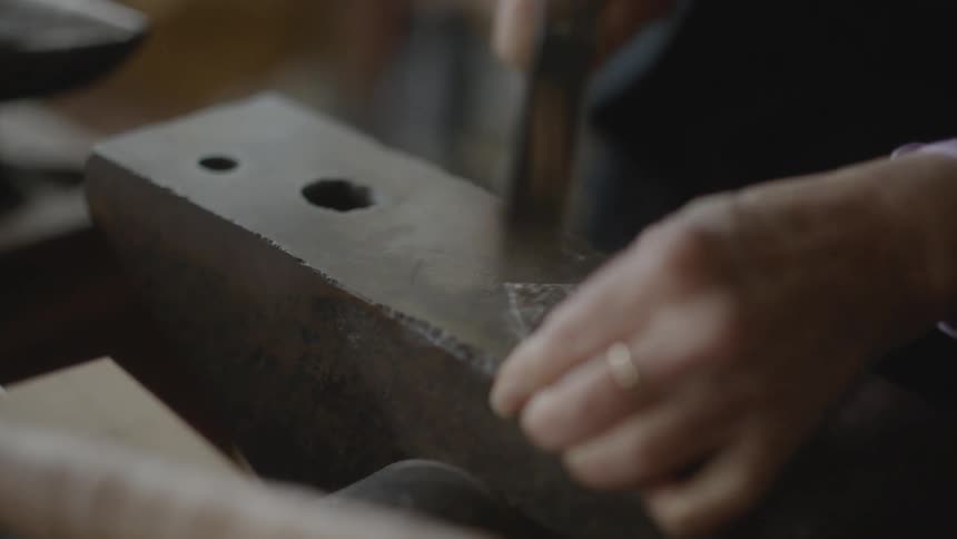 A clip of a person constructing with hammer