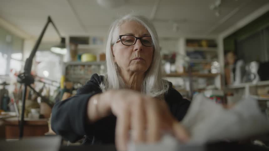 Portrait of a lady wrapping an object with her hands