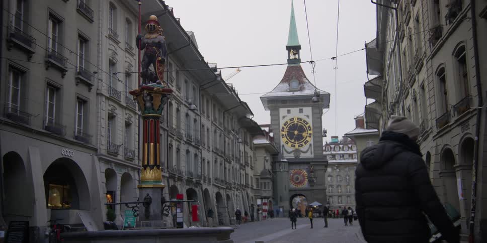 View of the Zahringerbrunnen bear statue in front of the Zytglogge Tower in Bern, Switzerland