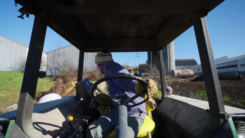 A clip of a man driving a farm truck