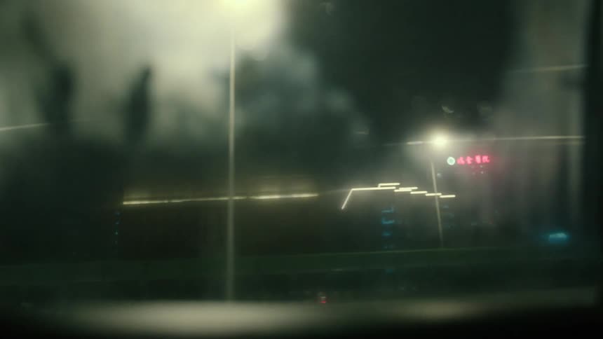 A car is driving on the road at night
