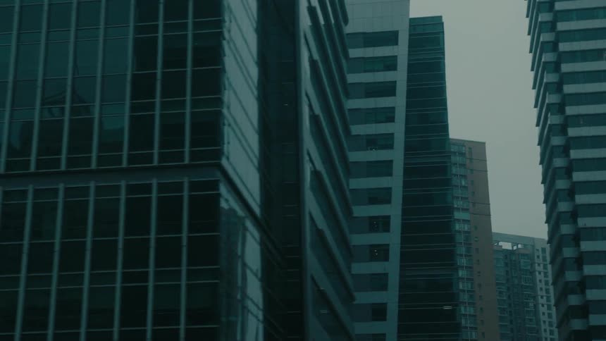 Skyscrapers and residential buildings in a metropolis on a cloudy day
