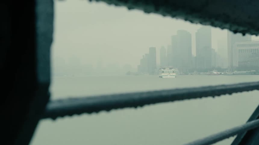 View from a bridge to a metropolis with skyscraper by the sea on a foggy day