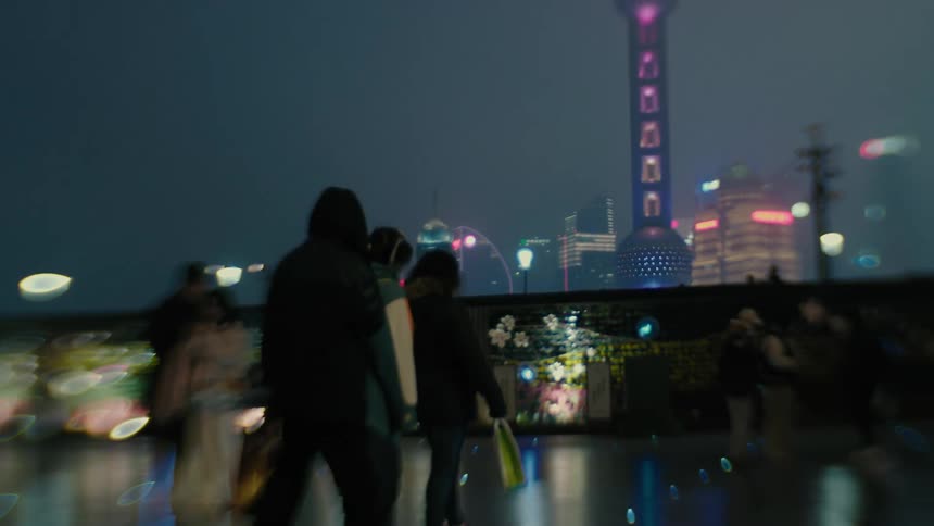 People are walking in the city at night