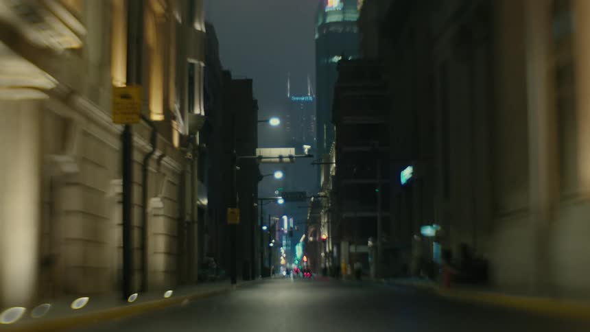 Traffic seen in the distance down a city street