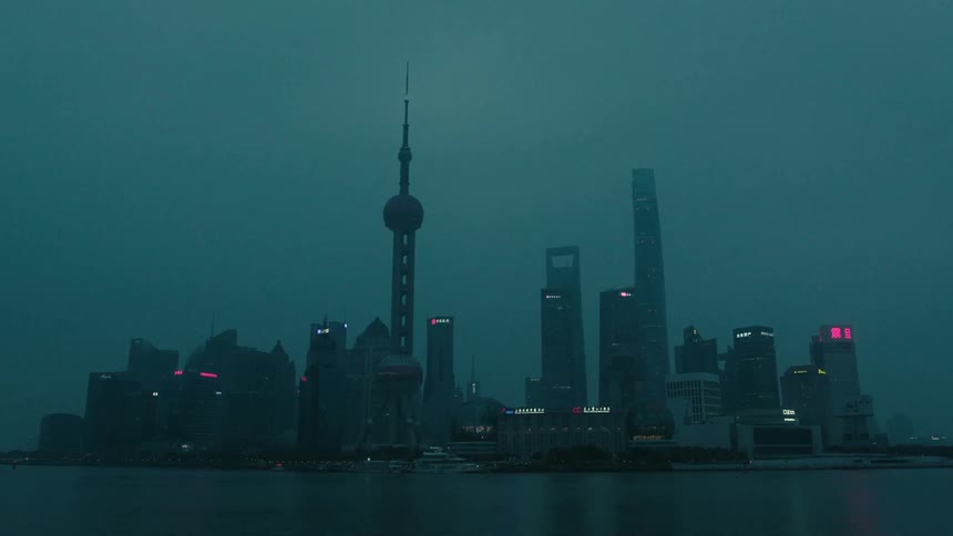 A coastal cityscape dominated by skyscrapers and spires