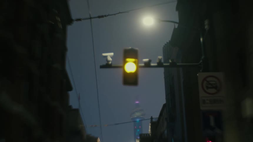 Traffic light closing in an alley in a suburb at night