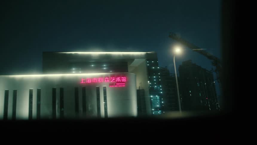 Buildings in the streets of shanghai at night seen from a moving vehicle