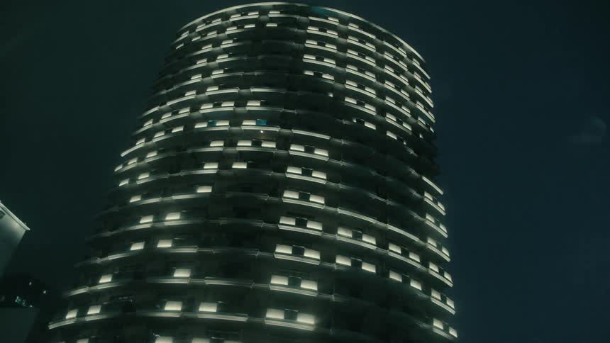 A tall building lit up at night