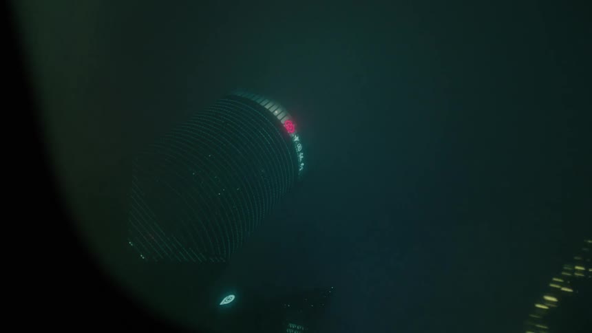 Point of view from the roof of a moving vehicle with a view of skyscrapers in a metropolis at night