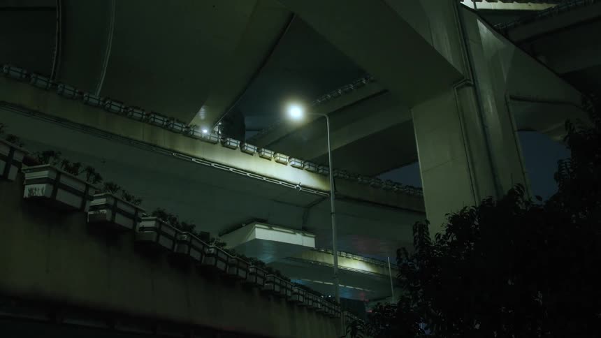 It is lit under the overpass at night