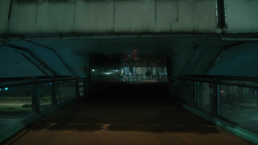 Empty walkway on a viaduct through the city at night