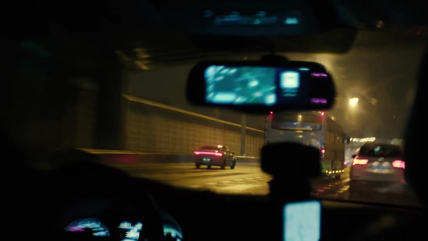A car follows other cars through a tunnel