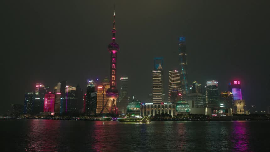 Shanghai metropolis scenery with skyscrapers and modern buildings by the sea at night
