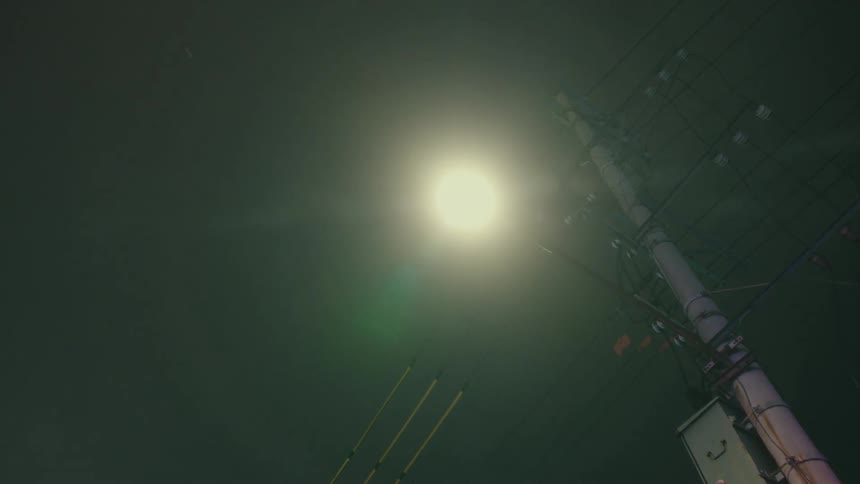 A streetlight and power lines at night