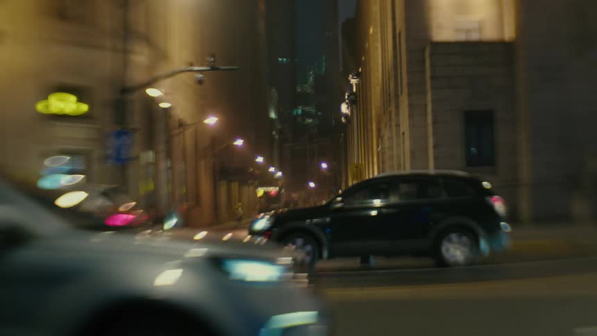 Vehicle traffic on a street at night in a metropolitan city