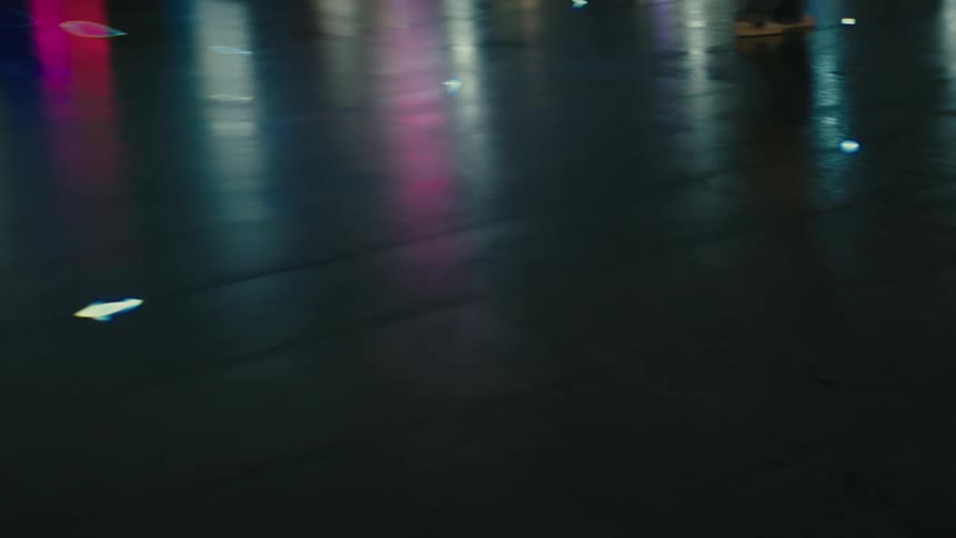 Reflection of colorful city lights on wet asphalt in the city at night