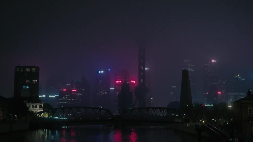 Waterfront shot of the shanghai city skyline on a foggy night