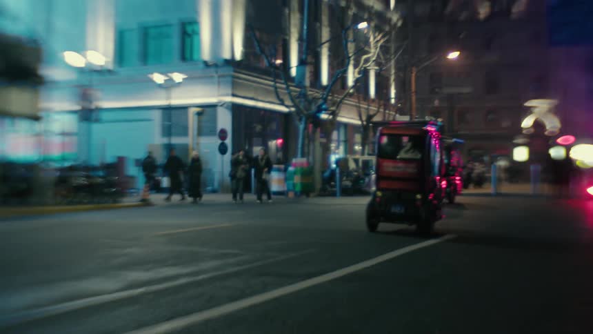 Rickshaws drive in the city at night