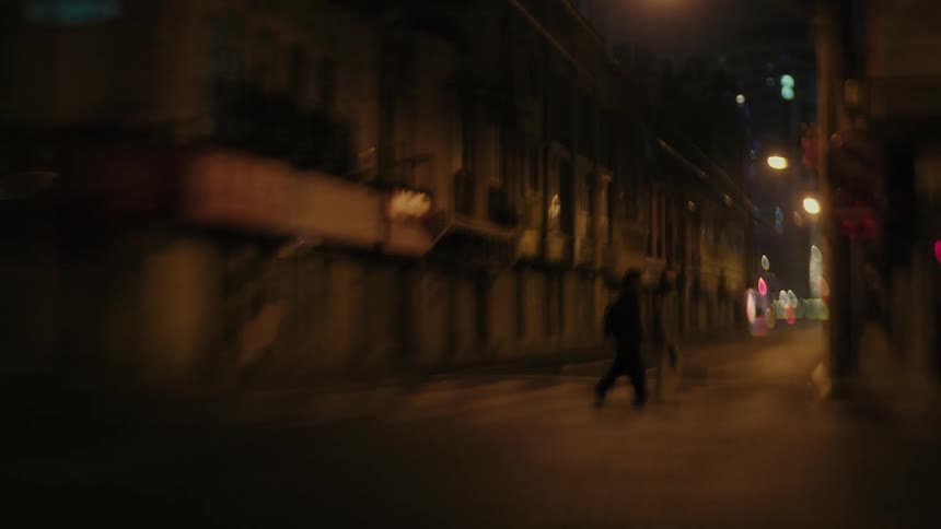 Pedestrians crossing the street in a suburban city at night