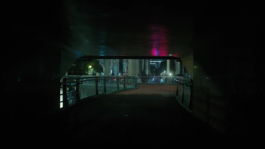 Corridor of a walkway in a metropolis at night
