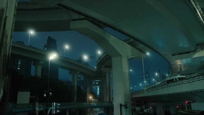 Panorama of an overpass in the middle of a metropolis at night with a van with a siren passing by
