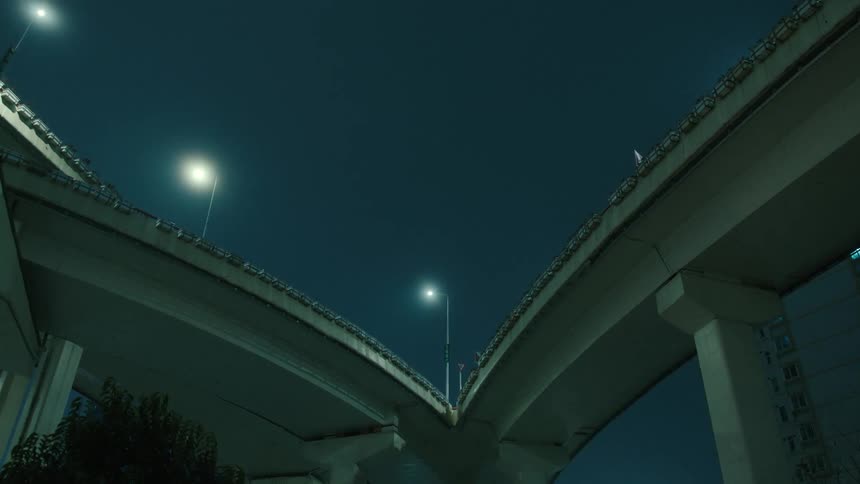Upward view of an overpass at night in the city