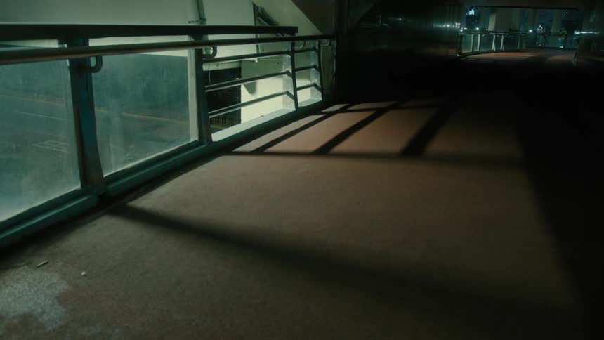 The dark hallway is covered in shadows