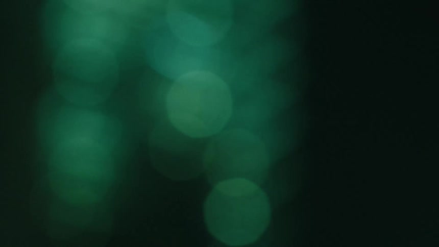Abstract reflection of greenish lights at night