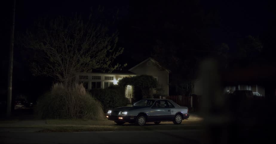 A night clip of a house and a car in a neighborhood