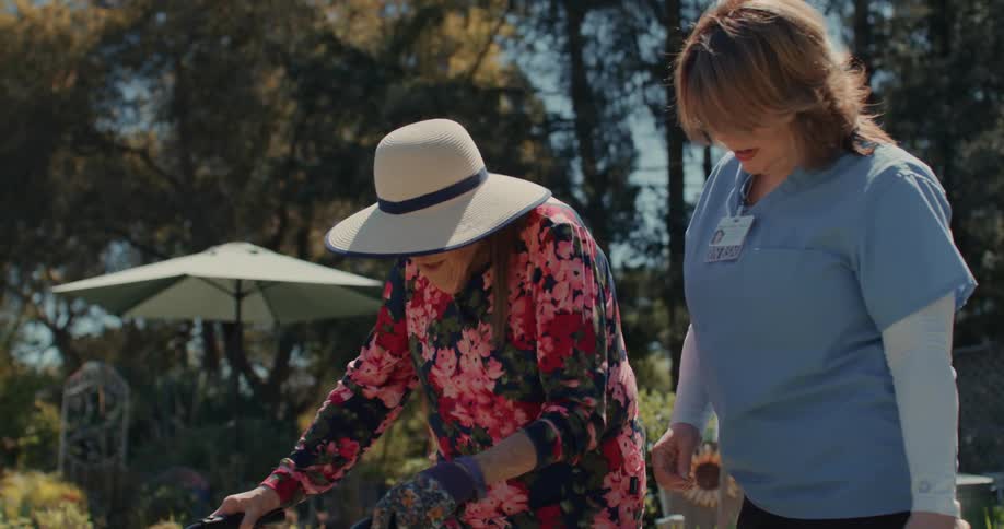 A clip of a nurse escorting an old lady