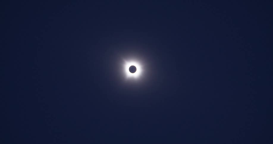 A full solar eclipse in a darkened sky