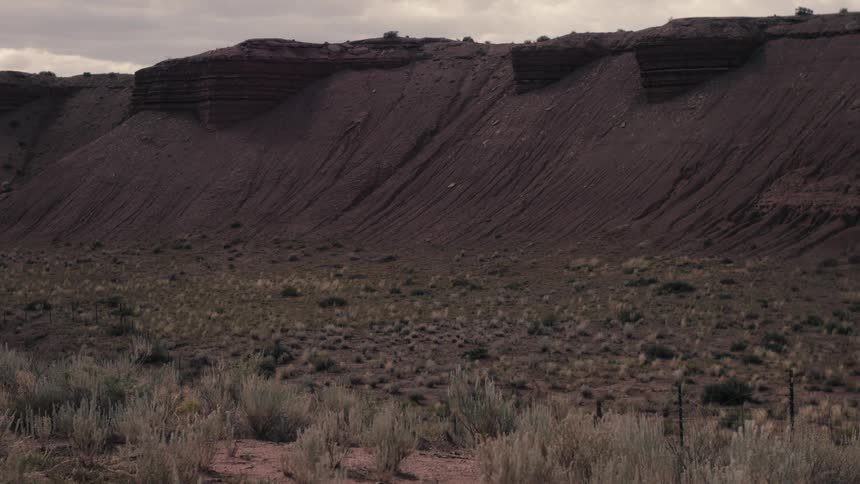 Time lapse of cloud shadows rolling over a barren landscape