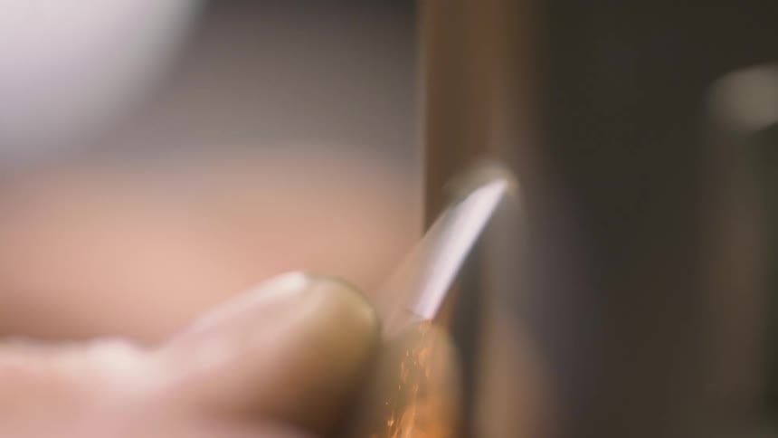 Close up of a hand grinding a metallic disc