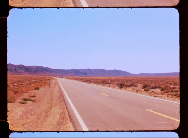 A road on a desert landscape caught on vintage film