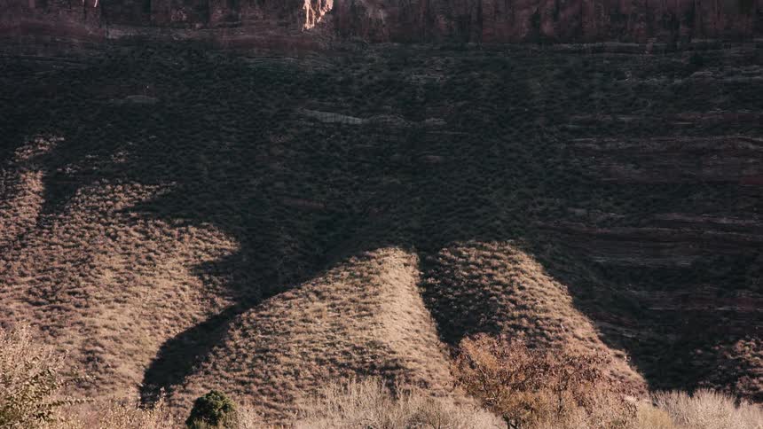 Time lapse of shadows moving over the slopes of a mountain