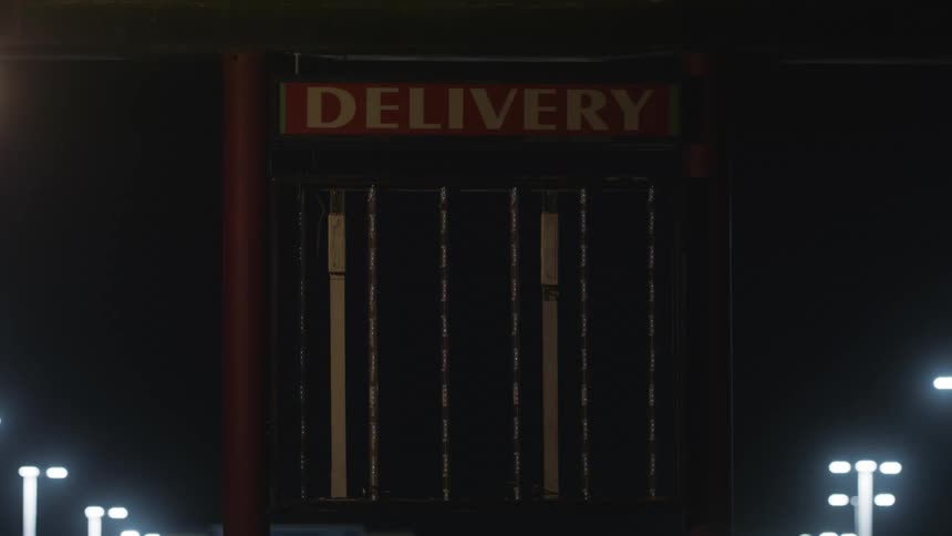 Closeup on a sign that flashes and says delivery