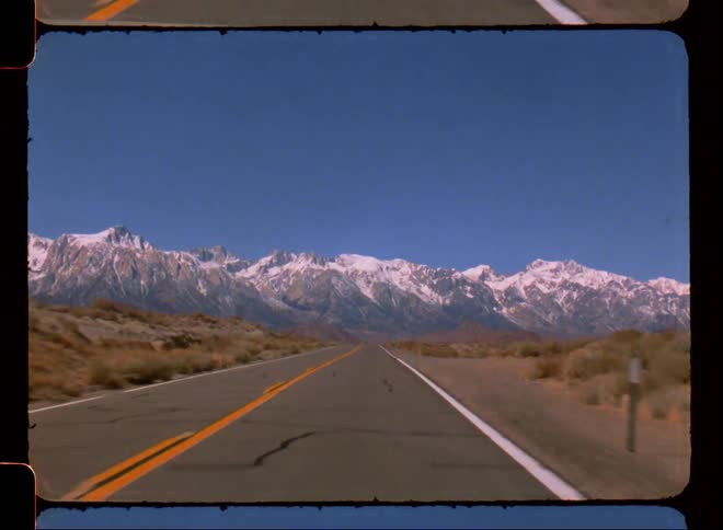The long highway leads to a mountain range